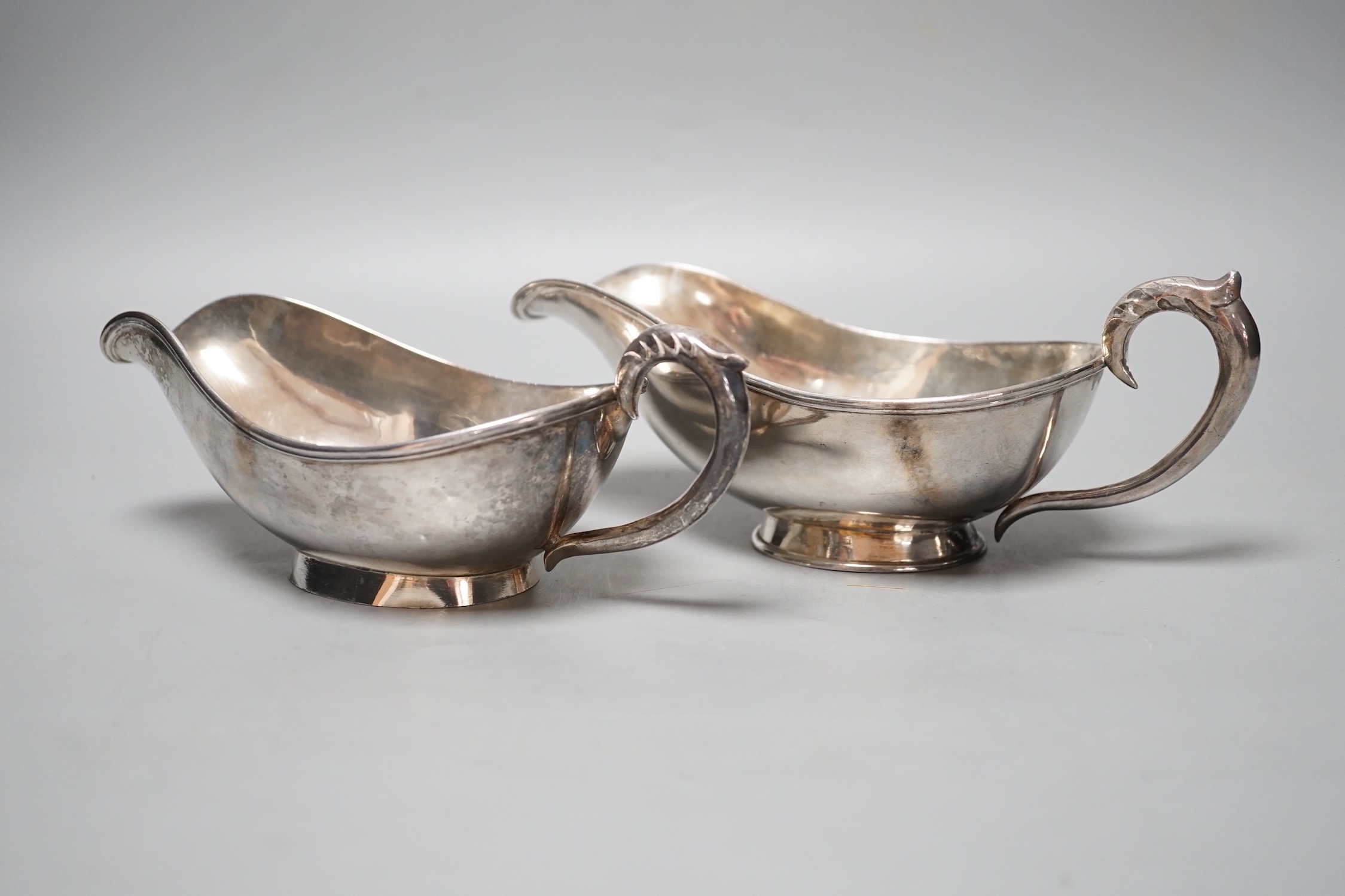 A pair of Chinese white metal sauce boats, by Yung Shun, 21.2cm, 11.5 grams.